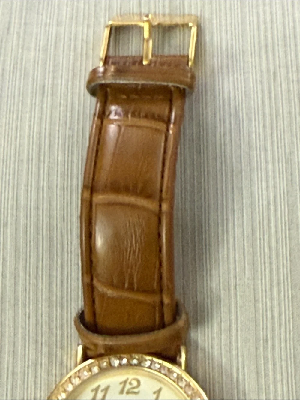 Disney Winnie the Pooh watch features a crystal-bezel dial and dangling charms o